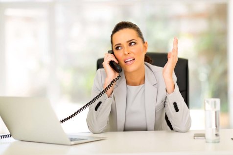office worker talking on landline phone